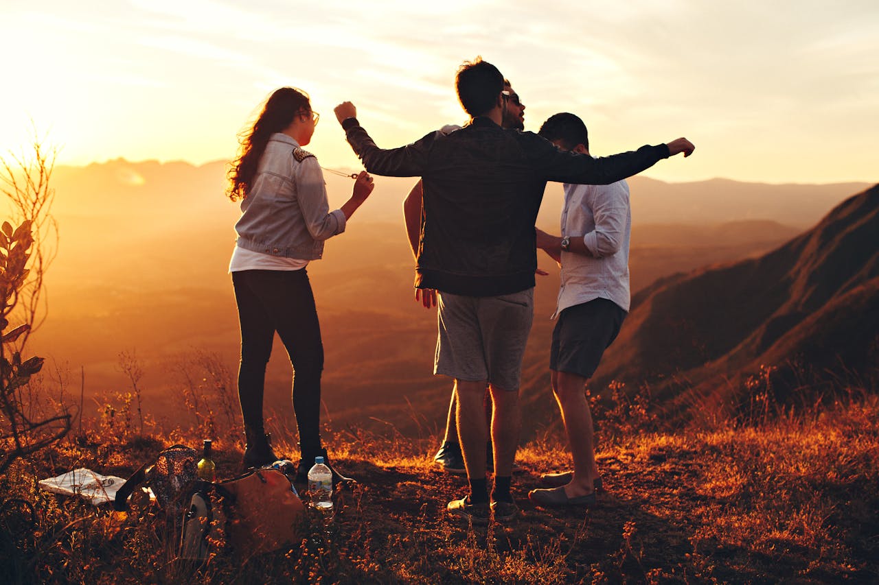 Services-03 Joyful group of young adults enjoying a sunset view in a mountainous landscape in Brazil.